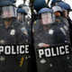 Police officers in riot gear look toward protesters along Reisterstown Road near Mondawmin Mall April 27, 2015, in Baltimore.
Drew Angerer/Getty Images